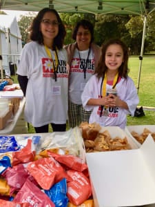 Two volunteers serving lunch at Run2Cure
