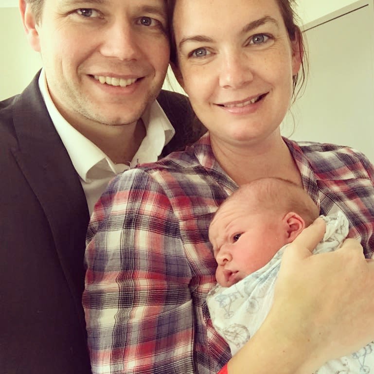 Baby Benji in the arms of his mum and dad